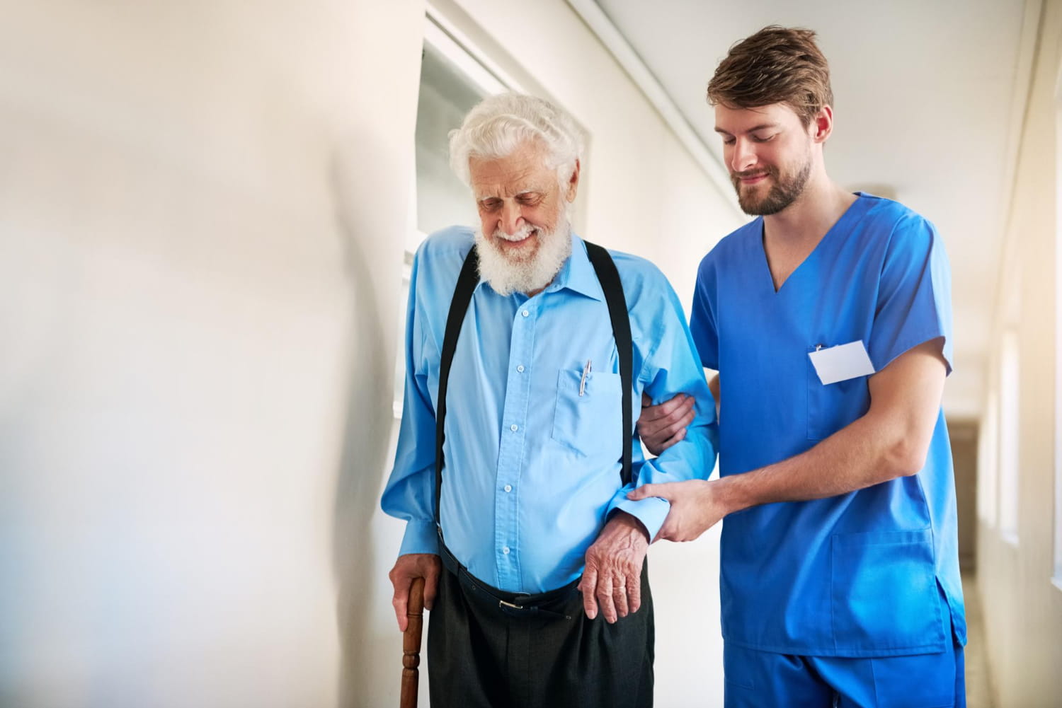 A carer helping an older man stay active and independent